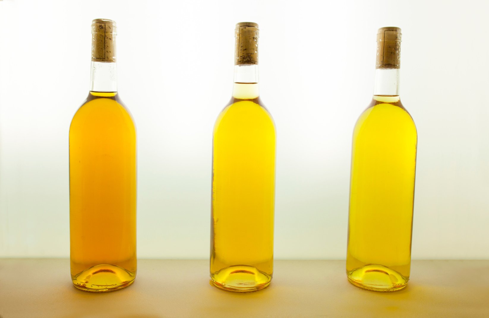 Three bottles of white wine with different tones